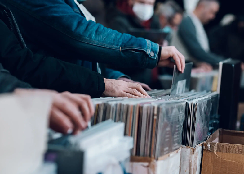 Hands browsing vinyl records at record fair