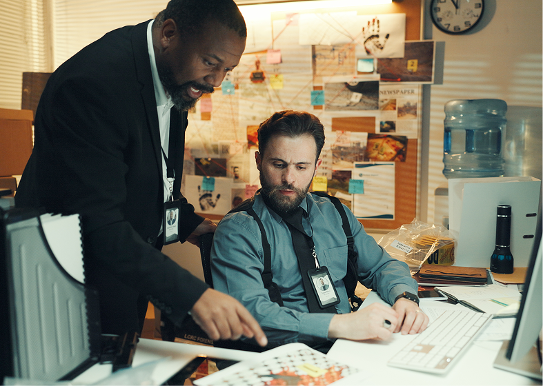 Two men analyzing case files