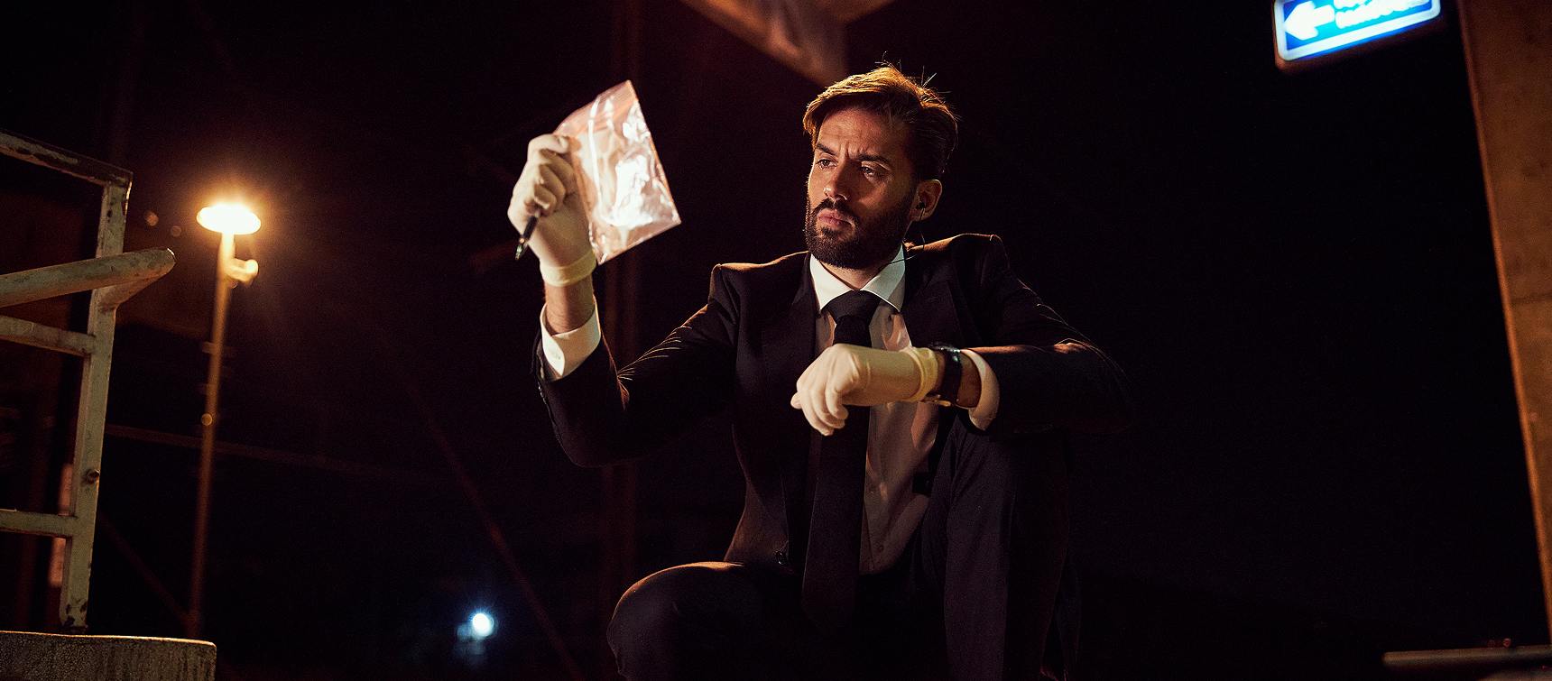 Detective examining evidence at night